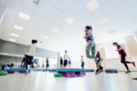 Blurred background of people group of girls playing in yoga and fitness,crossfit in the gym.の写真素材