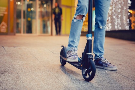 hipster man,  young on a scooter. Concept of mobile transport in the city.
