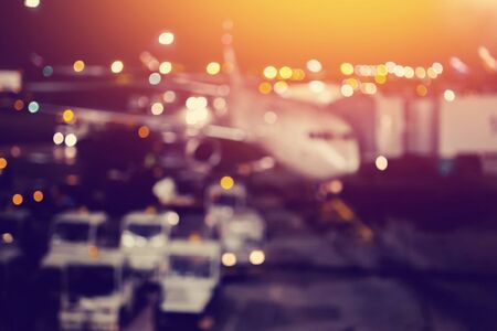 Blur of airplane airport background night against the lights, waiting for passengers. Abstract Blur of Plane in airport.の写真素材