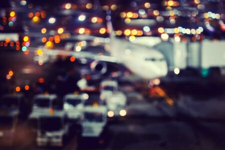Blur of airplane airport background night against the lights, waiting for passengers. Abstract Blur of Plane in airport.の写真素材