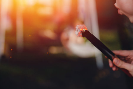 shisha hookah red hot coals, man blows coals for a hookah, sparks fly. Concept vacation with friends...