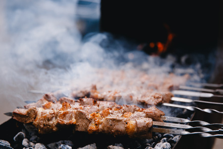 kebabs BBQ skewers of meat are cooked on coals and fire. Concept summer vacation, eating out.の写真素材