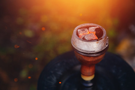 shisha hookah red hot coals. Sparks from breathe. Concept leisure in nature