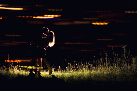 Lovers man and girl against background night city, night starry sky and horizon. Concept date Valentines Day, first kiss love, forever together.の写真素材