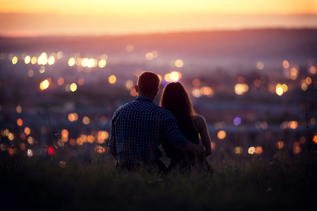 Lovers man and girl against background night city, night starry sky and horizon. Concept date Valentines Day, first kiss love, forever together.の写真素材