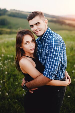 Lovers hold on to each others hand, touch and contact between a guy and a girl, on the hand of a guys watch. The concept of feelings, tenderness, support, help.の写真素材