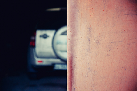 Close-up of a garage door, in the background a blurry car. background. Concept car repair, safety of cars. copy spaceの写真素材