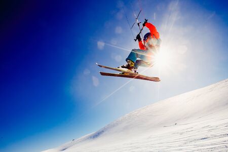 Skier with a kite on fresh snow in the winter in the tundra of Russia against a clear blue sky. Teriberka, Kola Peninsula, Russia. Concept of winter sports snowkite on ski.の写真素材