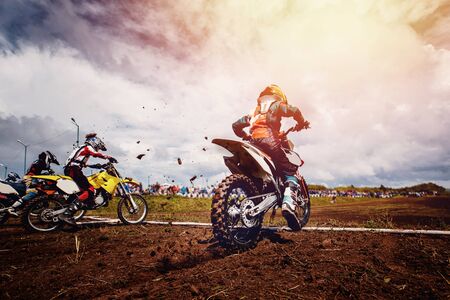Team of athletes on mountain bikes starts, smoke and dust fly from under the wheels cross-country.の写真素材