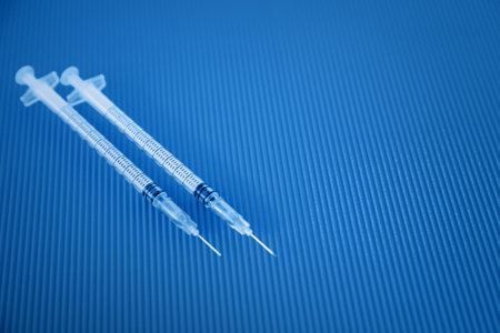 Medical syringe. Syringe for insulin on a blue background