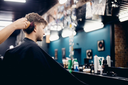 Man is doing a haircut. Mens hairdressers barber shopの写真素材