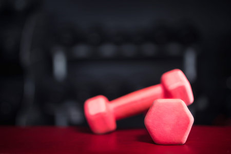 Dumbbells. Dumbbells pink for fitness dark background.