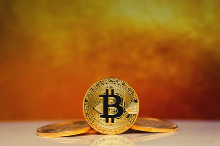 Gold Bitcoin on the gold background. Concept miningの写真素材