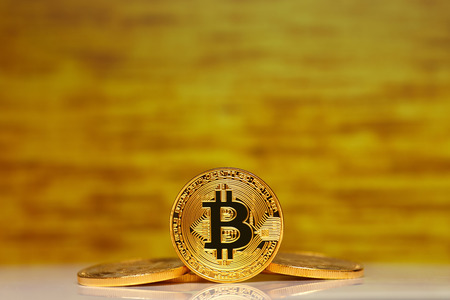 Gold Bitcoin on the gold background. Concept miningの写真素材