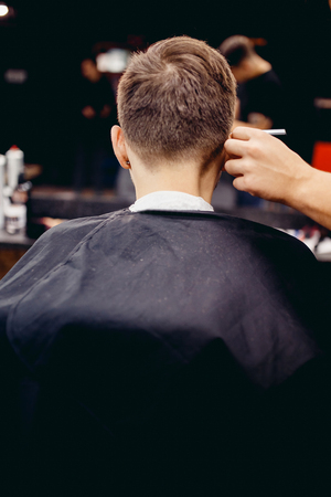 Man in a hair salon barber shop, rear view.の写真素材