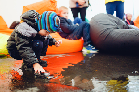 Houston, Texas - August 27, 2017: child plays with toys in a puddle of water. Heavy rains from hurricane Harvey.のeditorial素材