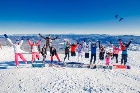 Sheregesh, Kemerovo region, Russia - April 16, 2016:  Group of merry people with skis and snowboards playのeditorial素材