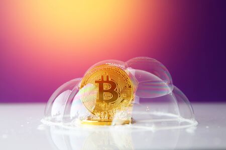 bitcoin. bitcoin in a soap bubble on purple background with sun lightの写真素材