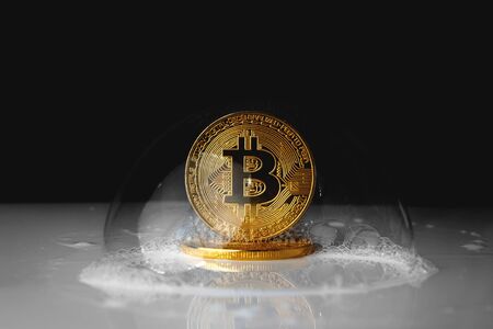 bitcoin. bitcoin in a soap bubble on black backgroundの写真素材