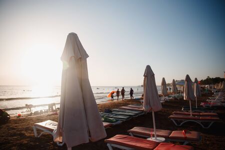 Beach loungers and umbrella on sunset, nobodyの写真素材