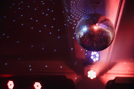 Disco ball with searchlight bright rays. Background night partyの写真素材