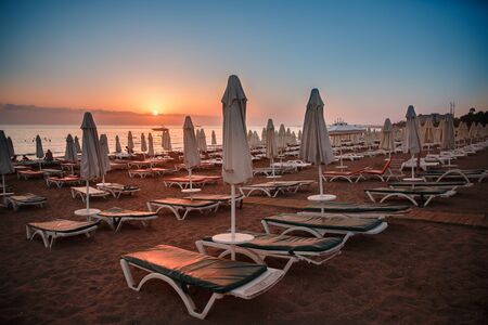 Beach loungers and umbrella on sunset, nobodyの写真素材