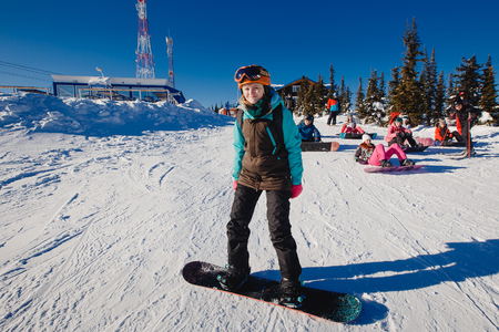 Sheregesh, Kemerovo region, Russia - April 16, 2016: Beginner snowboarder slides down the slopeのeditorial素材