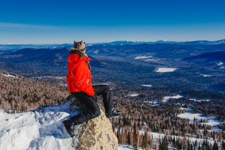 Sheregesh, Kemerovo region, Russia - April 16, 2016: Snowboarder in the background of mountains and blue skyのeditorial素材