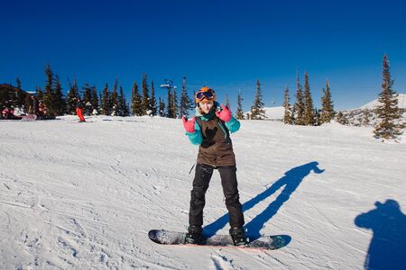 Sheregesh, Kemerovo region, Russia - April 16, 2016: Beginner snowboarder slides down the slopeのeditorial素材