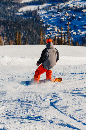 Sheregesh, Kemerovo region, Russia - April 16, 2016: snowboarder jumping in the mountains on a rockのeditorial素材