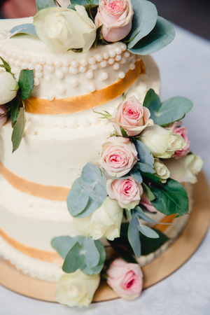 wedding cake with fresh flowers roses. three tiersの写真素材