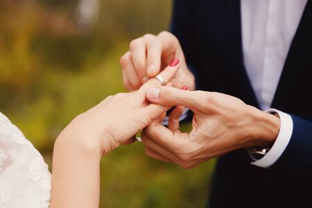 Marry me. Bride and grooms hands with wedding ringsの写真素材