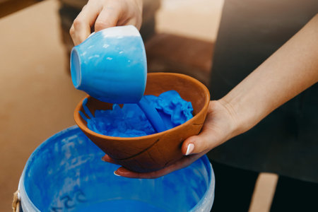 Ceramics, coating plates of dishes glaze. The process of applying color, handcraft, homemade