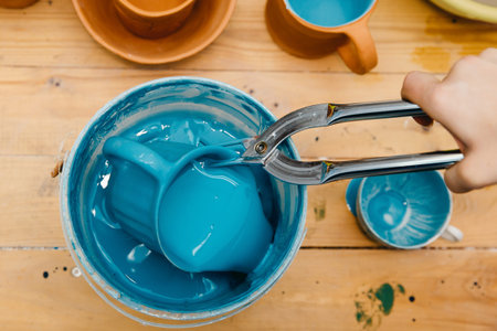 Ceramics, coating of mugs of glaze. Manufacturing processの写真素材