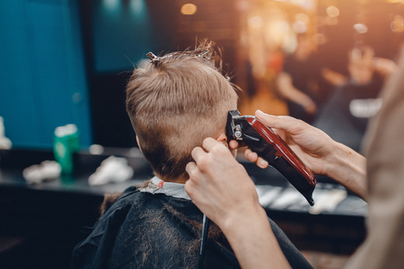 Barber shop. Barbershop Hairdresser makes hairstyle a man with a beard childの写真素材