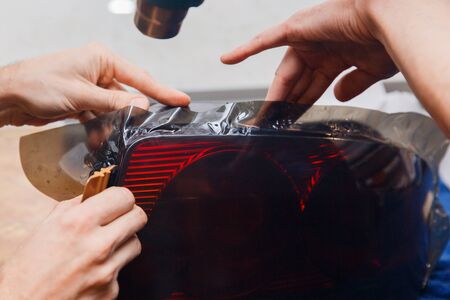 Masters tint car headlights with a film. Concept toning machine, carの写真素材