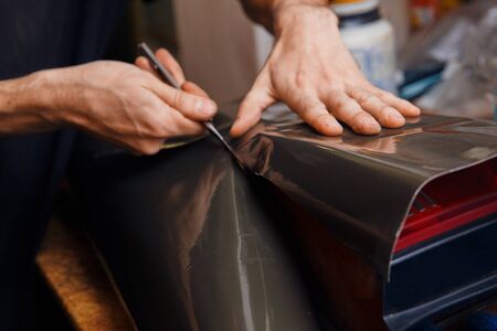 Masters tint car headlights with a film. Concept toning machine, car. Blur, Bluredの写真素材