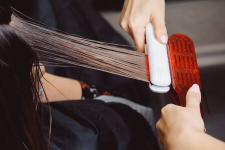 Keratin recovery hair and protein treatment pile with professional ultrasonic iron tool. Concept lamination, liftingの写真素材