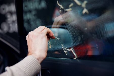 Master cleaning of glue from glass. Concept tinting car. Concept tinting carの写真素材
