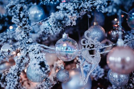 New Year's Toys xmas. Decorated Christmas tree on blurred, bokeh backgroundの写真素材