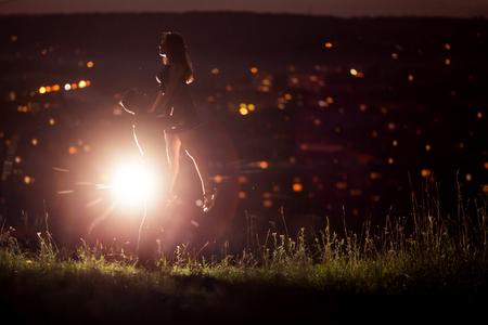 Texture with background for love: silhouette of loving couple against background of night city lights. Concept first love, feelings without boundaries, touch and flight of soul and consciousness. copyspaseの写真素材