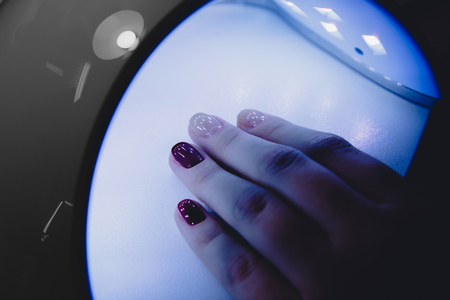 Instruments UV lamp gel manicure process in a beauty salon. Salon procedure.の写真素材