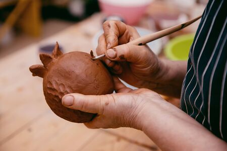 Ceramics. Master sculpts makes a plate according to the moldの写真素材