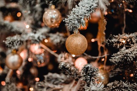 New Year's Toy ball on a background of a green Christmas tree. Concept knitted toysの写真素材