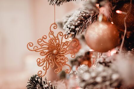 New Year's Toy ball snowflake on background of green Christmas tree. Concept knitted toysの写真素材