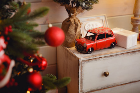 Gift New Year Machine car. Against the backdrop of a Christmas tree. Concept knitted toysの写真素材
