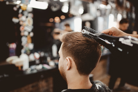 Barbershop. Close-up of a man's haircut, master Barber Shop does the hair stylingの写真素材