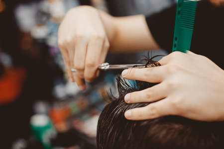 Barbershop. Man Barber in men's hairdresser does hair with scissors.