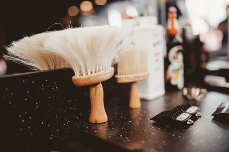 brush for shaving a beard along with a bowl, a blurred background of a hair salon for men, a barber...