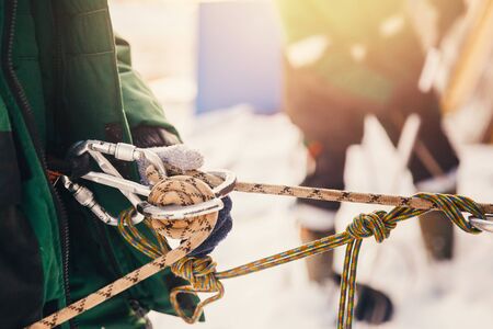 Close-up of safety belt and carbine, concept of cleaning roofs from snow in winterの写真素材